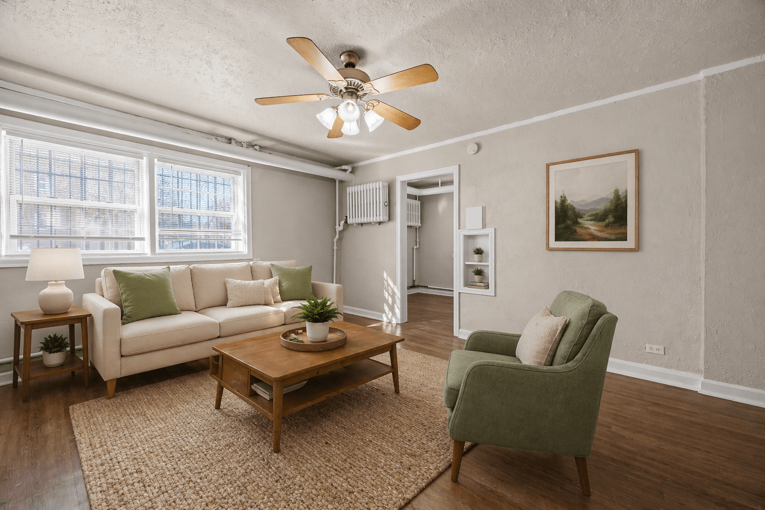 A living room with a white couch, green armchair, and a coffee table.,A living room with a white couch, green armchair, and a coffee table.